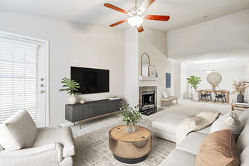 a living room with a large white couch and a large flat screen tv on the wall
